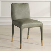 Pair of Uttermost Conifer dining chairs with wooden legs and fabric upholstery, showcasing elegant, modern design.