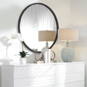 Black Dawsyn round accent mirror by Uttermost showing a sleek, circular mirror with a modern black frame.