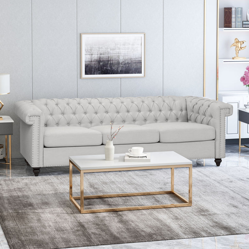 Noble House Chesterfield style 3-seater sofa with deep button tufting and rolled arms, showcasing luxurious upholstery and classic design.