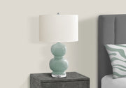 Modern 8th Street contemporary table lamp with a sleek design and neutral-colored shade, ideal for living room or bedside lighting.