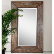 Large dark brown wood wall mirror with a sleek, rectangular frame by Uttermost, showcasing a modern and elegant design.