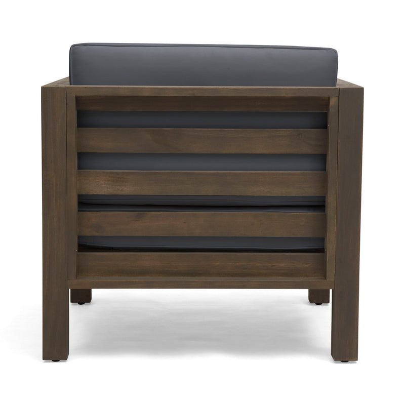 Noble House outdoor acacia wood patio arm chair with fabric cushion, showing a sturdy wooden frame and comfortable seating for outdoor spaces.