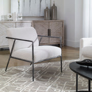 Uttermost Brisbane accent chair in light gray fabric with a modern, upholstered design and wooden legs.