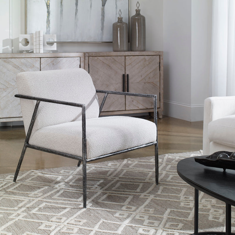 Uttermost Brisbane accent chair in light gray fabric with a modern, upholstered design and wooden legs.