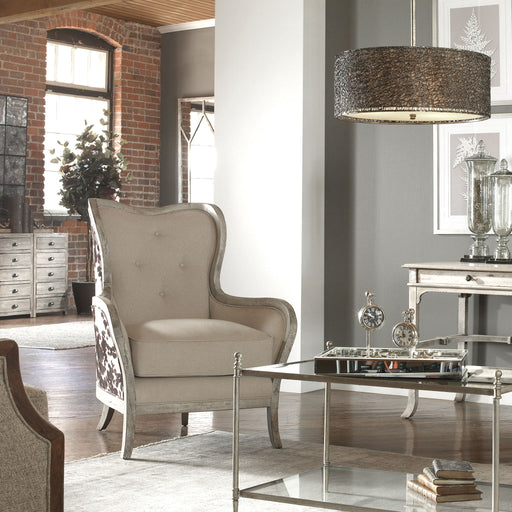 White high-back armchair by Uttermost, Chalina style, showcasing plush upholstery and elegant design in a modern living space.