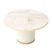 Michael Amini Gineverra round cocktail table in ivory and gold with elegant curved legs and decorative details.