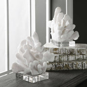 Pair of white Charbel bookends by Uttermost, featuring modern design, holding books on a shelf with smooth finishes.