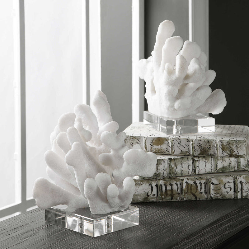 Pair of white Charbel bookends by Uttermost, featuring modern design, holding books on a shelf with smooth finishes.