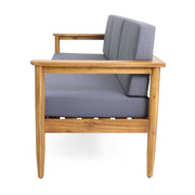 Dark gray outdoor 3 seater sofa with cushions and teak acacia wood frame by Noble House. Perfect for patio lounging.