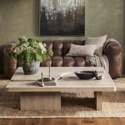 Modern Melina coffee table by Classic Home featuring a sleek wooden surface and sturdy metal legs.