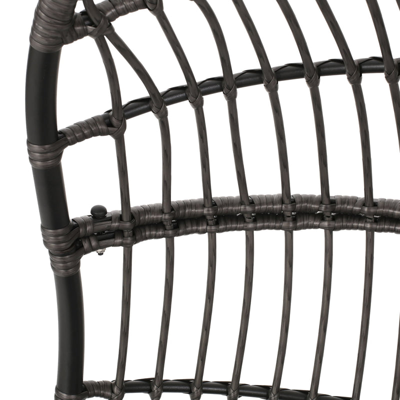 Rustic Noble House hanging basket chair with cushion, featuring a woven design and cozy fabric cushion for indoor or outdoor relaxation.