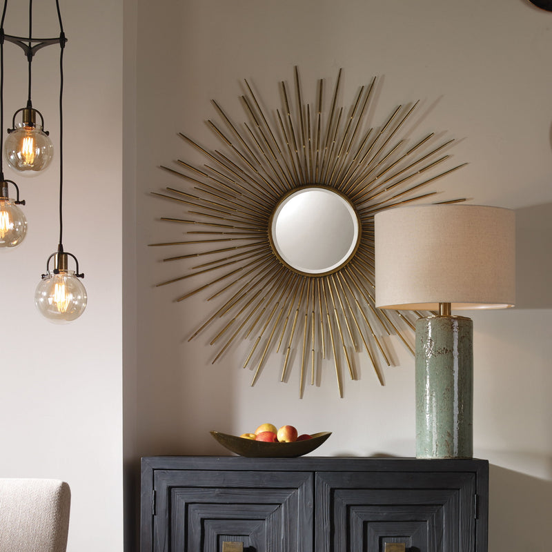 Golden Rays Starburst Mirror by Uttermost, a gold wall mirror with a radiant starburst design and decorative frame.