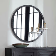 Uttermost Dandridge round industrial wall mirror with a metal frame, ideal for modern or rustic interior decor.