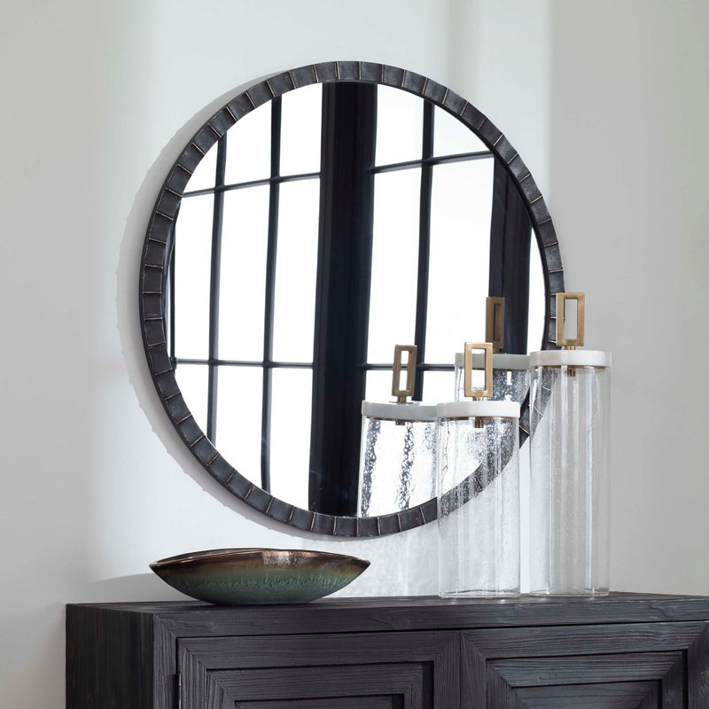 Uttermost Dandridge round industrial wall mirror with a metal frame, ideal for modern or rustic interior decor.