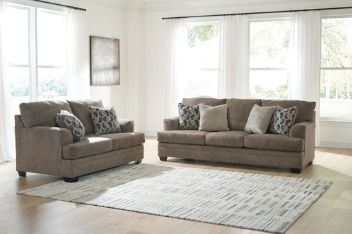 Three-piece living room set by Signature Design Ashley featuring a sofa, loveseat, and armchair with neutral upholstery.