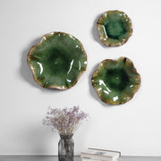 Set of three ceramic wall decor pieces by Uttermost, featuring modern abstract designs for stylish wall decoration.