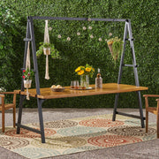Noble House Huckleberry outdoor dining table in teak with acacia wood finish and built-in plant hanger, designed for outdoor use.