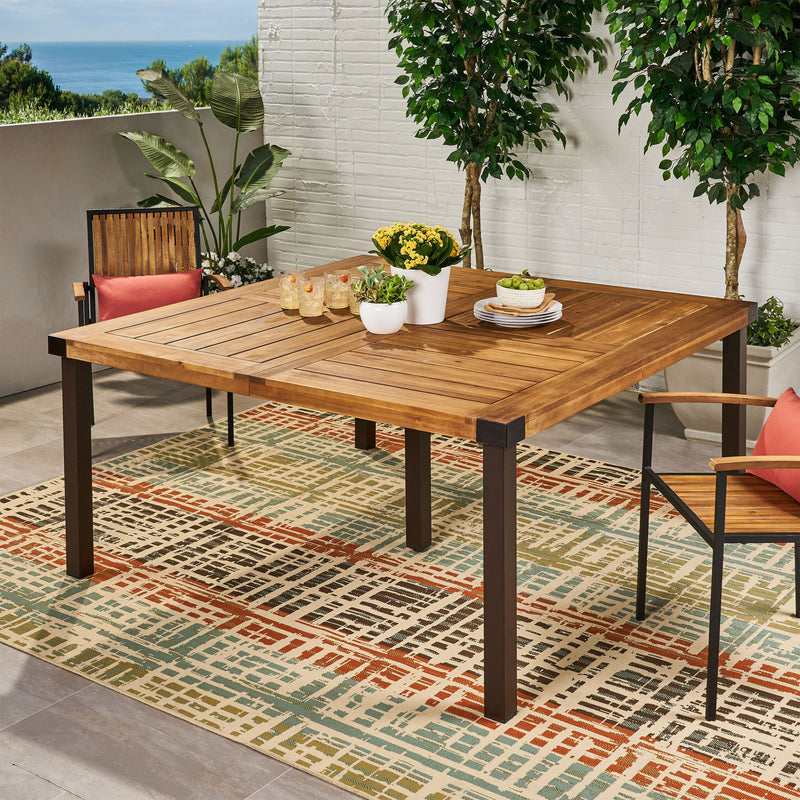 Modern industrial dining table by Noble House with acacia wood slats and teak finish, showcasing a sturdy, stylish design.