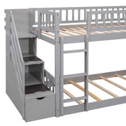 DreamHaus gray twin over twin bunk bed with stairway, two drawers, and slide, featuring a sturdy wooden frame and safety railings.
