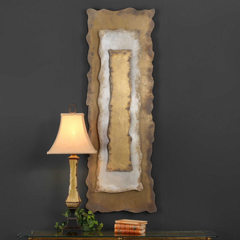 Uttermost Jaymes oxidized gold wall decor panel with intricate geometric design on a neutral background.