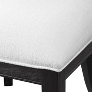 Uttermost Idris armless side chair with upholstered seat and wooden legs, modern design perfect for living or dining spaces.
