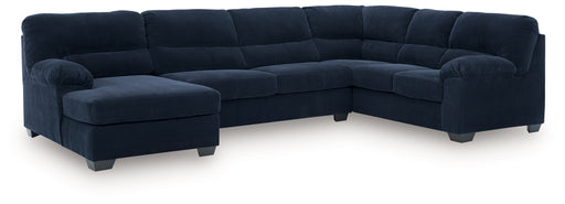 Signature Design by Ashley SimpleJoy stationary sectional sofa with plush cushions and neutral fabric in a modern living room setting.
