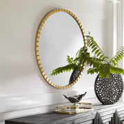 Uttermost Dandridge round industrial wall mirror with a metal frame, ideal for modern industrial interior decor.