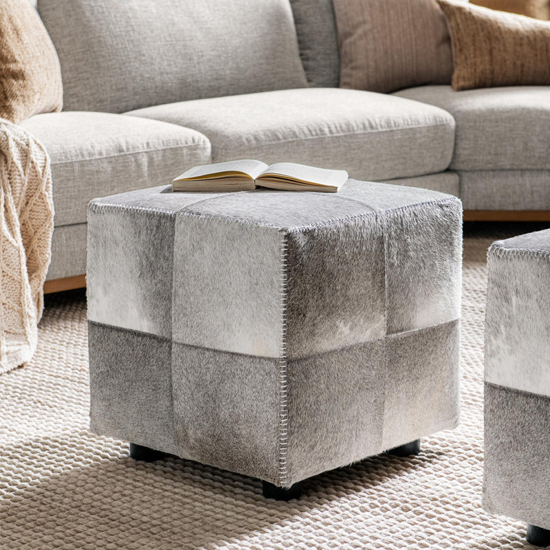 Square upholstered Landyn Ottoman in Sparrow Gray with tufted top, from Classic Home, showcasing a stylish and comfortable living room accent.