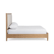 Upholstered bed by Classic Home with plush fabric headboard and frame, showcasing a modern and comfortable bedroom centerpiece.