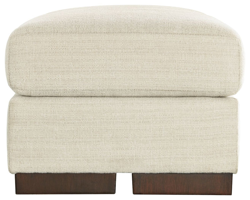 Signature Design by Ashley Maggie upholstered ottoman with a plush fabric top and wooden legs, versatile for living room decor.