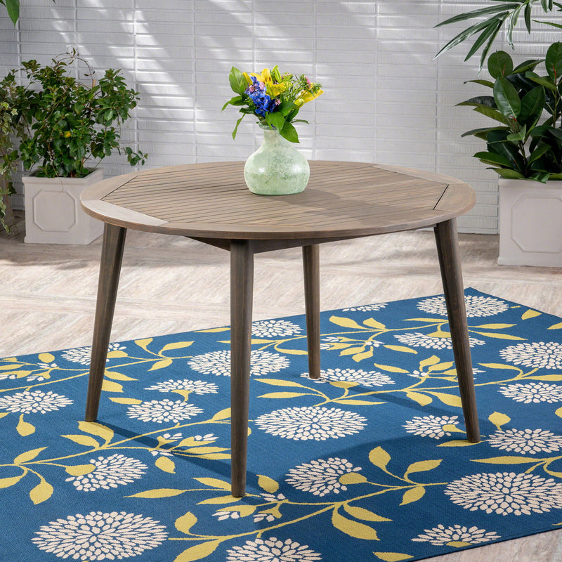 Modern Noble House Stamford outdoor dining table with sleek design, featuring a spacious flat surface and sturdy legs.