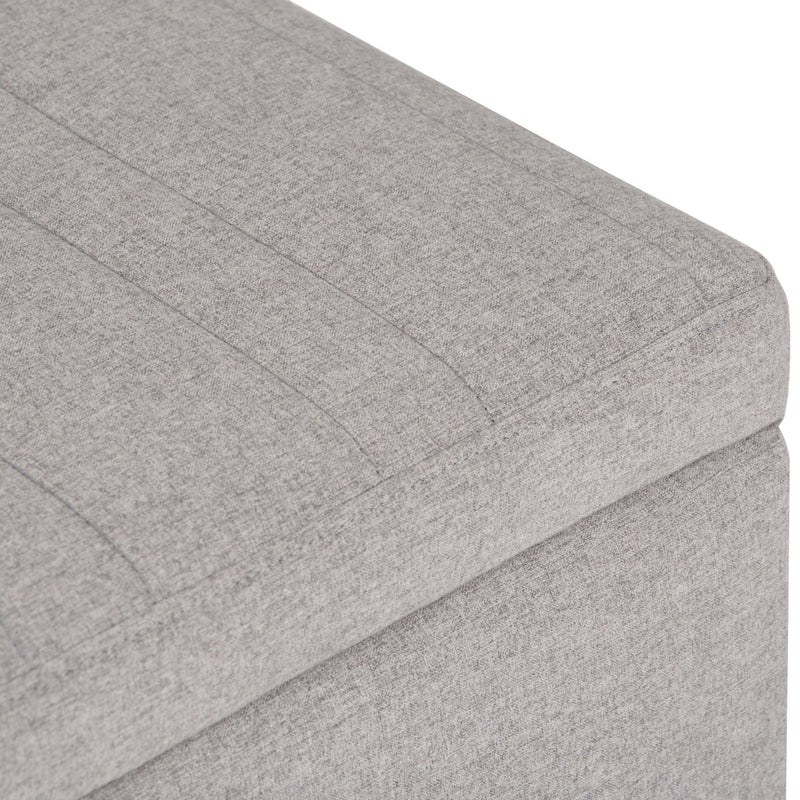 Simpli-Home Monroe upholstered storage ottoman with soft fabric top and wooden legs, versatile for living room or bedroom use.