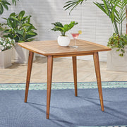 Modern indoor square acacia wood dining table with toothpick leg design, crafted by Noble House, showcasing sleek, stylish furniture.