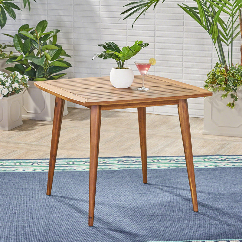 Modern indoor square acacia wood dining table with toothpick leg design, crafted by Noble House, showcasing sleek, stylish furniture.