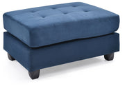Contemporary upholstered ottoman by Glory Furniture with a plush fabric surface and modern design, ideal for living room decor.