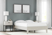 Signature Design by Ashley Socalle platform bed with a sleek wooden frame and modern headboard, shown in a contemporary bedroom setting.