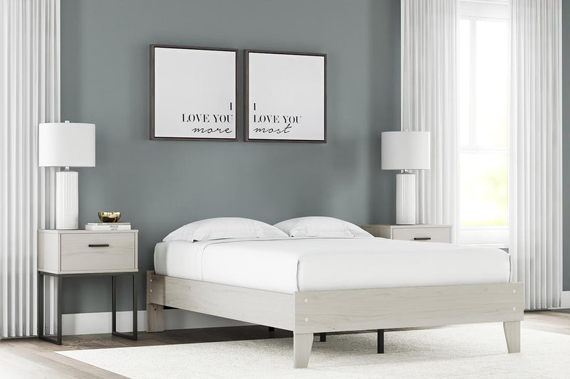 Signature Design by Ashley Socalle platform bed with a sleek wooden frame and modern headboard, shown in a contemporary bedroom setting.