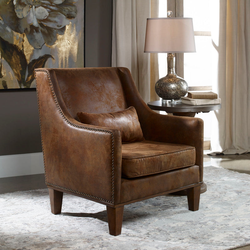 Dark brown leather armchair by Uttermost with a sturdy frame and plush cushioning, featuring a classic arm chair design.