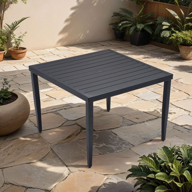 Outdoor patio dining table by Life Outside with tapered feet and umbrella hole, ideal for outdoor dining spaces.