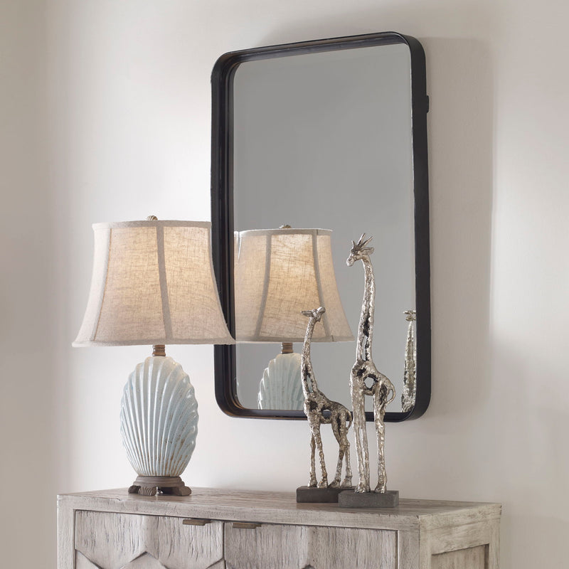 Black Croften vanity mirror by Uttermost featuring a sleek, rectangular design with a modern frame and reflective glass surface.