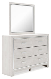 Seven-piece upholstered storage bedroom set by Signature Design by Ashley, including bed, dressers, and storage options.