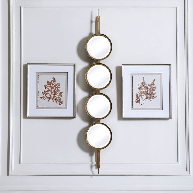 Uttermost wall mirror with a stylish button design, featuring a round frame and modern decorative details.