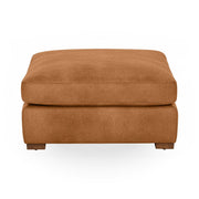 Classic Home Audrey upholstered ottoman with plush fabric and sturdy wooden legs, perfect as a footrest or accent piece.