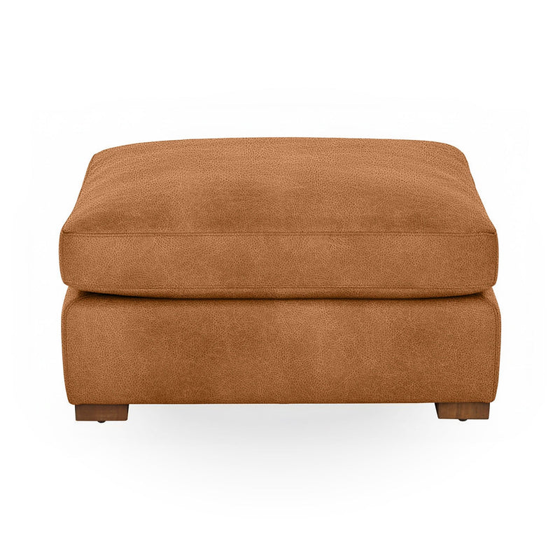 Classic Home Audrey upholstered ottoman with plush fabric and sturdy wooden legs, perfect as a footrest or accent piece.