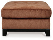 Ashley® Laylabrook oversized accent ottoman in plush spice fabric with dark wood trim, square shape with soft cushioning.