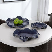 Set of three ceramic wall decor pieces by Uttermost, featuring textured, artistic designs for modern interior decoration.
