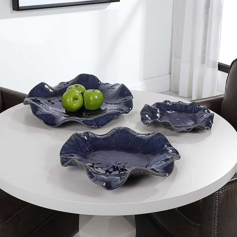 Set of three ceramic wall decor pieces by Uttermost, featuring textured, artistic designs for modern interior decoration.