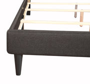 Upholstered button-tufted bed by Glory Furniture with cozy fabric and elegant design, perfect for stylish bedroom spaces.