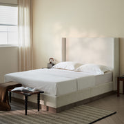 House & Home Furniture Hosford minimalist upholstered wingback bed with wood base platform, showcasing a modern, padded headboard and sturdy frame