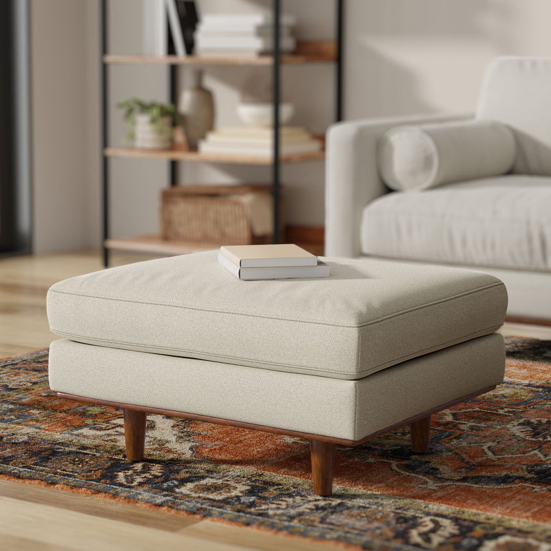 Simpli-Home Morrison handcrafted upholstered ottoman with cushioned top and wooden legs, ideal for living room decor.